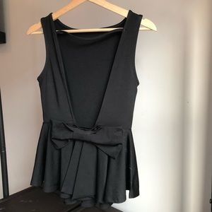 Peplum low back top with bow accent
